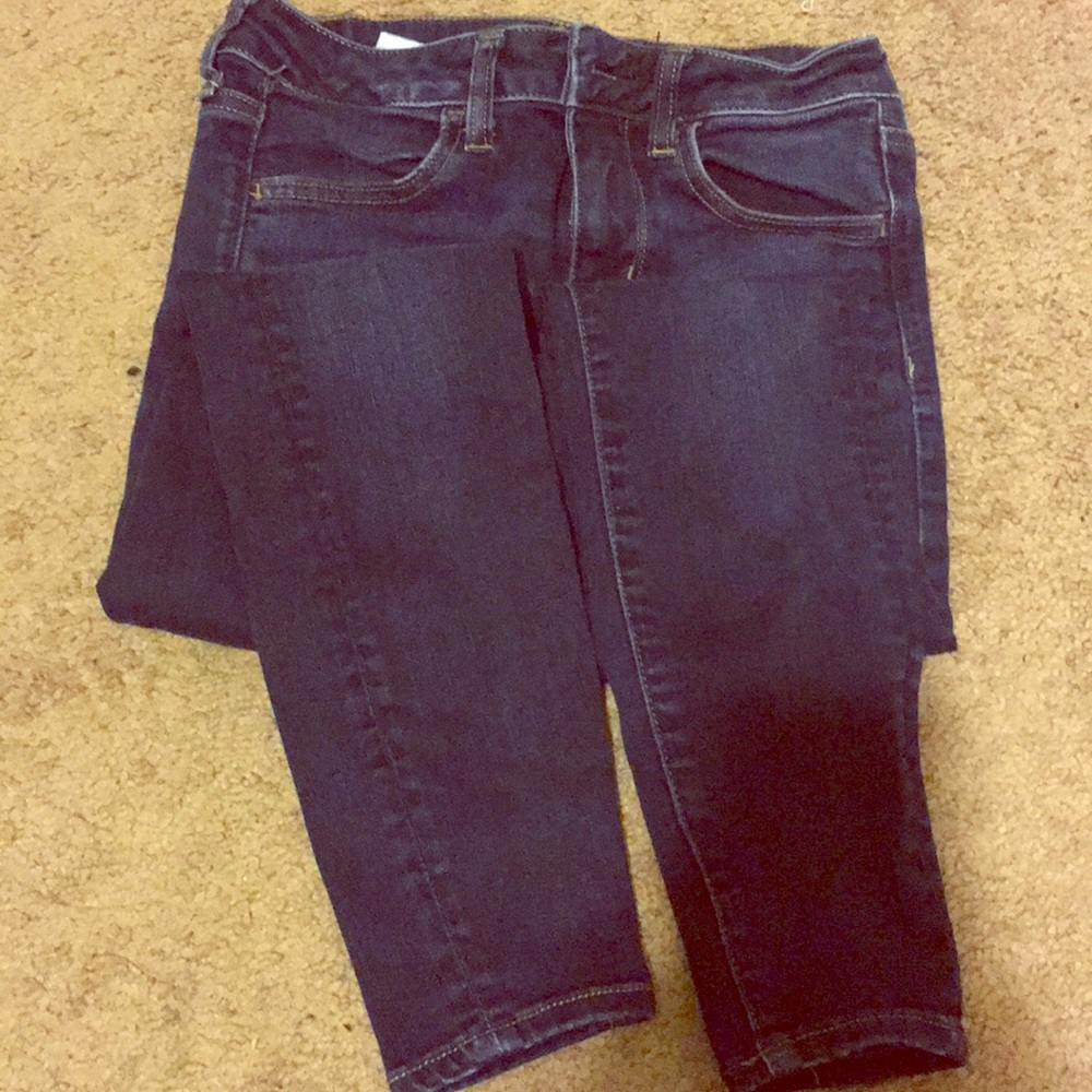 Dark-wash skinny jeans.